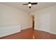 Open bedroom featuring wood floors, white walls, and a modern dresser at 193 Longview Ave # 203, Celebration, FL 34747