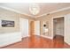 Bedroom featuring gleaming wood floors, ample lighting, and a flat screen television at 193 Longview Ave # 203, Celebration, FL 34747
