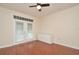 Light-filled bedroom features wood flooring, white walls, and sliding glass door to the outside at 193 Longview Ave # 203, Celebration, FL 34747