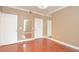 A well-lit bedroom featuring wood flooring and reflective mirror accents at 193 Longview Ave # 203, Celebration, FL 34747
