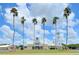 Community clubhouse with palm trees, a lawn, and a white windmill at 193 Longview Ave # 203, Celebration, FL 34747