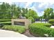 Dog park entrance with a statue of a dog on a pedestal surrounded by green shrubs and trees at 193 Longview Ave # 203, Celebration, FL 34747