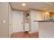 Bright entryway featuring a white front door, modern storage, and sleek wood flooring at 193 Longview Ave # 203, Celebration, FL 34747