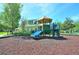 Community playground with colorful play structure, slides, and a soft landing surface at 193 Longview Ave # 203, Celebration, FL 34747