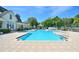 A large rectangular pool with blue water surrounded by several lounge chairs at 193 Longview Ave # 203, Celebration, FL 34747
