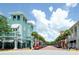 Charming street view lined with palm trees and boutique shops in a vibrant community at 193 Longview Ave # 203, Celebration, FL 34747