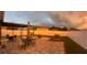 Expansive backyard with a pergola, fire pit, stylish pavers, and ambient string lights, perfect for evening gatherings at 1940 Egret Meadows Ave, Kissimmee, FL 34744