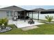 Spacious backyard featuring a pergola-covered patio, a fire pit area, and lush landscaping, perfect for outdoor enjoyment at 1940 Egret Meadows Ave, Kissimmee, FL 34744