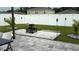 Serene backyard with a tiled patio, fire pit, and lush landscaping, perfect for outdoor entertaining at 1940 Egret Meadows Ave, Kissimmee, FL 34744