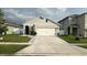 Charming single-story home with a well-manicured lawn and attached two-car garage at 1940 Egret Meadows Ave, Kissimmee, FL 34744
