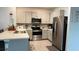 Modern kitchen featuring stainless steel appliances, granite countertops, and ample cabinet space at 1940 Egret Meadows Ave, Kissimmee, FL 34744