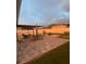 Charming backyard patio with outdoor seating, elegant lighting, and a cozy fire pit area for gatherings at 1940 Egret Meadows Ave, Kissimmee, FL 34744