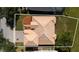 Aerial view of home shows tile roof and pristine landscaping with a neatly edged lawn at 1950 Windward Oaks Ct, Kissimmee, FL 34746