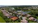 Aerial view of a neighborhood with lush greenery, lakes, and well-maintained lawns at 1950 Windward Oaks Ct, Kissimmee, FL 34746