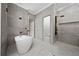 Modern bathroom featuring a freestanding tub, walk-in shower, and contemporary fixtures, offering a spa-like experience at 1950 Windward Oaks Ct, Kissimmee, FL 34746