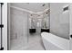 Modern bathroom with a freestanding tub, glass enclosed shower, and double vanity sinks at 1950 Windward Oaks Ct, Kissimmee, FL 34746