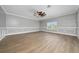 Spacious bedroom with light wood floors, decorative molding, and a ceiling fan, offering a serene retreat at 1950 Windward Oaks Ct, Kissimmee, FL 34746