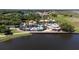Aerial view of a beautiful community pool next to a lake with covered pavilion at 1950 Windward Oaks Ct, Kissimmee, FL 34746