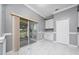 Bright dining area with tile flooring, white cabinets, built-in storage, and a sliding glass door to the outdoor patio at 1950 Windward Oaks Ct, Kissimmee, FL 34746