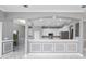 Modern kitchen with white cabinets, stainless steel appliances, breakfast bar, and gray walls with white trim at 1950 Windward Oaks Ct, Kissimmee, FL 34746