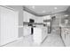 Modern kitchen with white cabinetry, stainless steel appliances, quartz countertops, and a center island at 1950 Windward Oaks Ct, Kissimmee, FL 34746