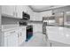 Bright and updated kitchen with stainless steel appliances, white cabinets and luxurious countertops at 1950 Windward Oaks Ct, Kissimmee, FL 34746