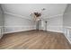 Spacious living room with hardwood floors, crown molding, and neutral paint at 1950 Windward Oaks Ct, Kissimmee, FL 34746
