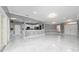 Open-concept living area with tile flooring, gray walls, and white trim, leading to the kitchen with a breakfast bar at 1950 Windward Oaks Ct, Kissimmee, FL 34746