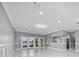 Spacious living room featuring a marble tile floor, recessed lighting, and French door access to the backyard at 1950 Windward Oaks Ct, Kissimmee, FL 34746