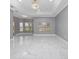 Bright living room featuring marble floors, modern lighting, and ample natural light, ideal for relaxation and entertainment at 1950 Windward Oaks Ct, Kissimmee, FL 34746