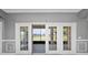 A bright enclosed patio with French doors overlooking the lake, offering a relaxing space for outdoor enjoyment at 1950 Windward Oaks Ct, Kissimmee, FL 34746