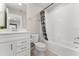 A bathroom with a white cabinet sink, a toilet and a tiled shower and tub at 2223 Bluebird Pl, St Cloud, FL 34771