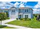 Charming two-story home featuring a well-manicured lawn and beautiful landscaping at 2223 Bluebird Pl, St Cloud, FL 34771