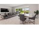 Open-concept living room with dining area and sliding glass doors to the backyard at 2223 Bluebird Pl, St Cloud, FL 34771