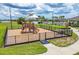 View of the fenced-in neighborhood playground, adjacent to the community pool and clubhouse at 2223 Bluebird Pl, St Cloud, FL 34771