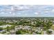 Expansive aerial view of a residential neighborhood with lush greenery and beautiful blue skies filled with white clouds at 2569 Tandori Cir, Orlando, FL 32837
