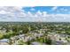 Expansive aerial view of a residential neighborhood with tree-lined streets on a partly cloudy day at 2569 Tandori Cir, Orlando, FL 32837