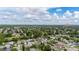 Expansive aerial view of a residential neighborhood with tree-lined streets on a partly cloudy day at 2569 Tandori Cir, Orlando, FL 32837