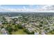 Neighborhood aerial view shows tree-lined streets, well-maintained houses, and nearby green spaces and ponds at 2569 Tandori Cir, Orlando, FL 32837