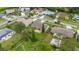 Aerial view of a backyard featuring a patio set with a privacy fence and well-maintained lawn surrounded by lush landscaping at 2569 Tandori Cir, Orlando, FL 32837
