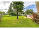Expansive backyard featuring a lush lawn, outdoor patio, and established landscaping at 2569 Tandori Cir, Orlando, FL 32837