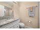 This bathroom features a granite countertop with a single sink and white cabinets with a mirror above at 2569 Tandori Cir, Orlando, FL 32837