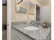 Bathroom featuring a granite countertop vanity with a mirror and decorative seashells at 2569 Tandori Cir, Orlando, FL 32837
