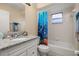 Bathroom with granite countertop vanity, tub, shower, and colorful fish-themed shower curtain at 2569 Tandori Cir, Orlando, FL 32837