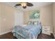 Bedroom featuring hardwood floors, ceiling fan, a window and closet with sliding doors at 2569 Tandori Cir, Orlando, FL 32837