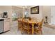 Bright dining area with a wooden table, six chairs, and a large window providing natural light at 2569 Tandori Cir, Orlando, FL 32837