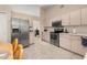 Spacious kitchen featuring stainless steel appliances, light wood cabinets, and tile flooring at 2569 Tandori Cir, Orlando, FL 32837