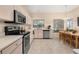 Bright kitchen featuring stainless steel appliances, light wood cabinets, and tiled flooring at 2569 Tandori Cir, Orlando, FL 32837