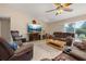 Comfortable living room featuring tile flooring, plush seating, and a large screen television at 2569 Tandori Cir, Orlando, FL 32837