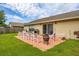 Outdoor patio space with seating, grill, and sliding glass doors leading into the home at 2569 Tandori Cir, Orlando, FL 32837